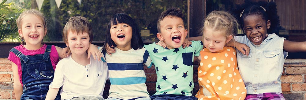 Six Young Children Sitting with Their Arms Around One Another